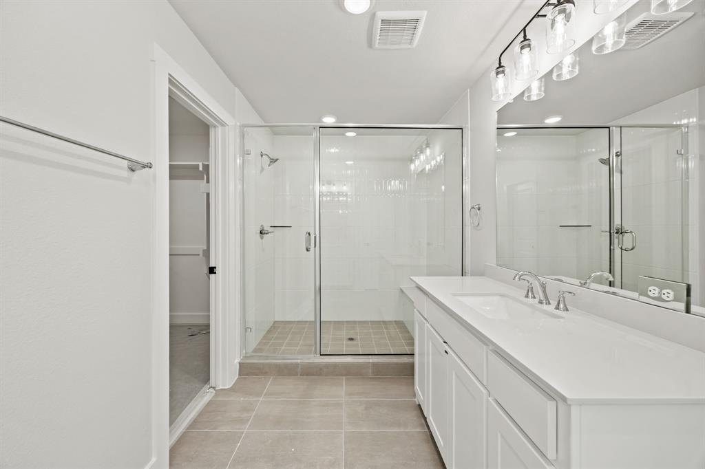 317 Chestnut Street Celina, TX 75009 - Photo 23 of 30 a bathroom with a double vanity sink mirror double and shower