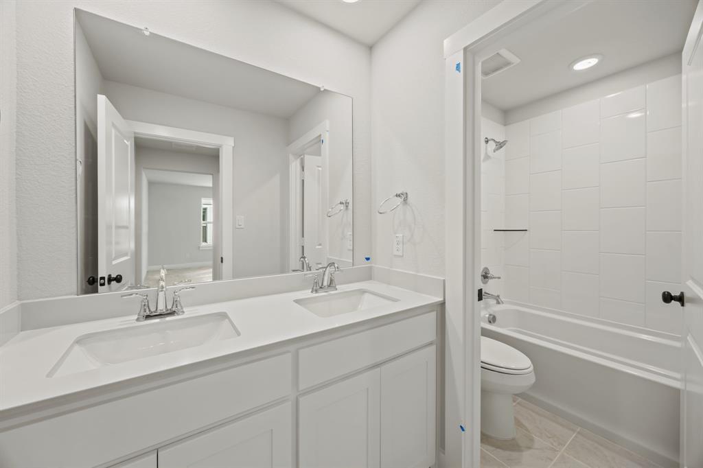 317 Chestnut Street Celina, TX 75009 - Photo 26 of 30 a bathroom with a sink a toilet and shower