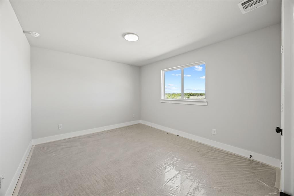 317 Chestnut Street Celina, TX 75009 - Photo 27 of 30 an empty room with a window