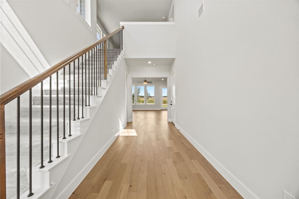 317 Chestnut Street Celina, TX 75009 - Photo 5 of 30 a view of a hallway with wooden floor and staircase
