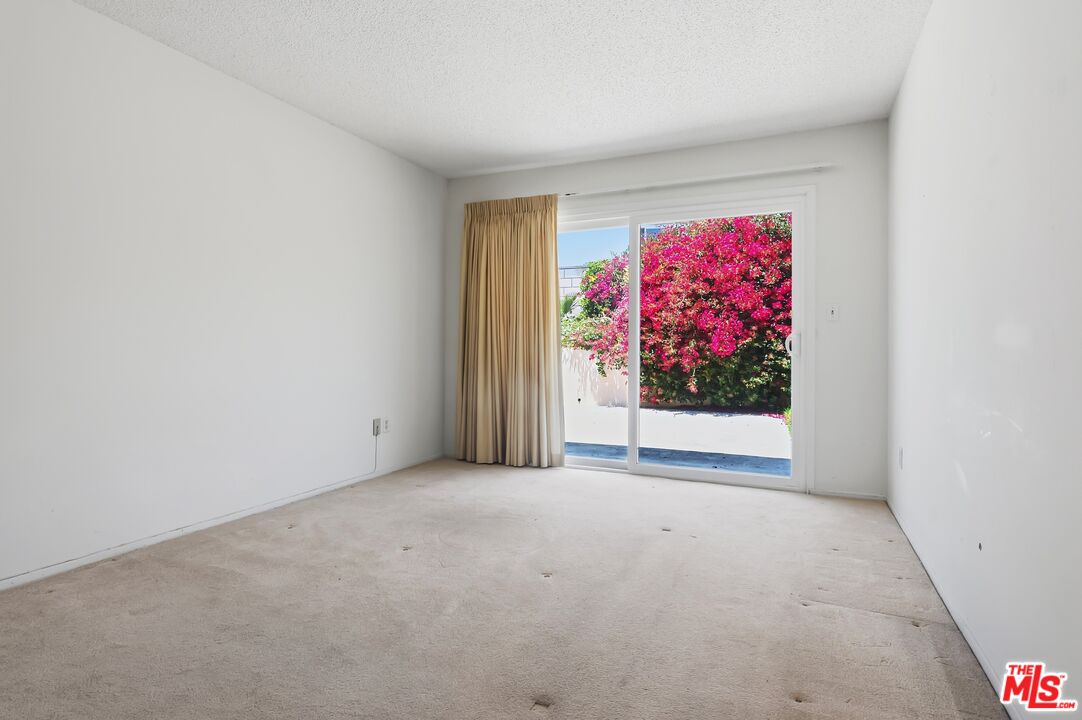 19131 Tulsa Street Porter Ranch, CA 91326 - Photo 17 of 43 a view of an empty room with a painting on the wall