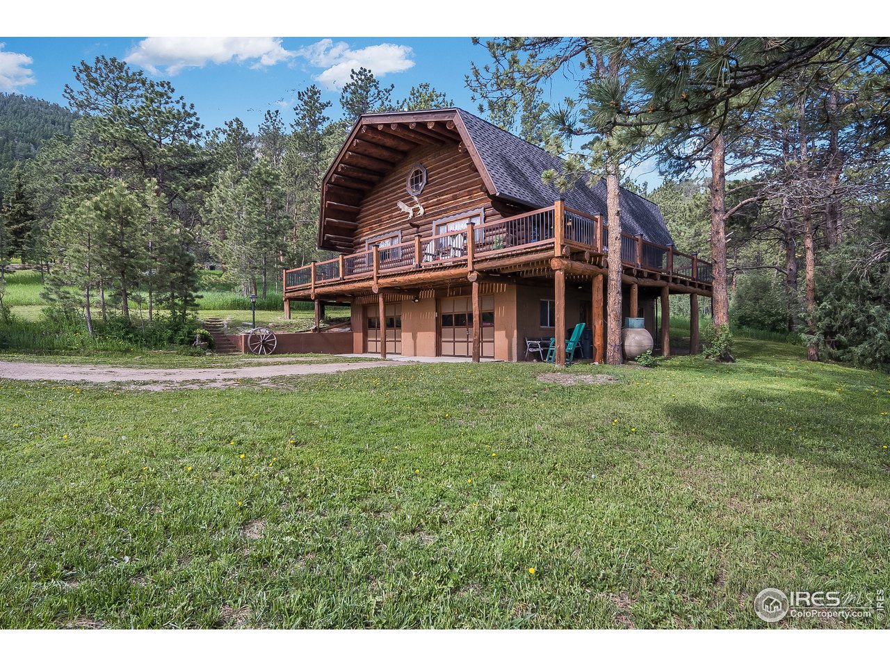 49 Moose Road Lyons, CO 80540 - Photo 11 of 40 a view of a big house with a big yard and large trees
