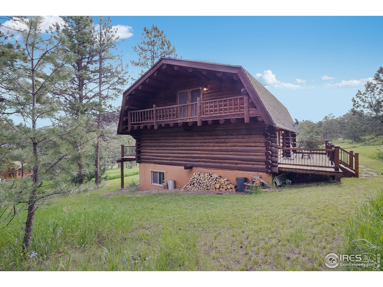 49 Moose Road Lyons, CO 80540 - Photo 13 of 40 a view of a backyard with barbeque grill and a bench
