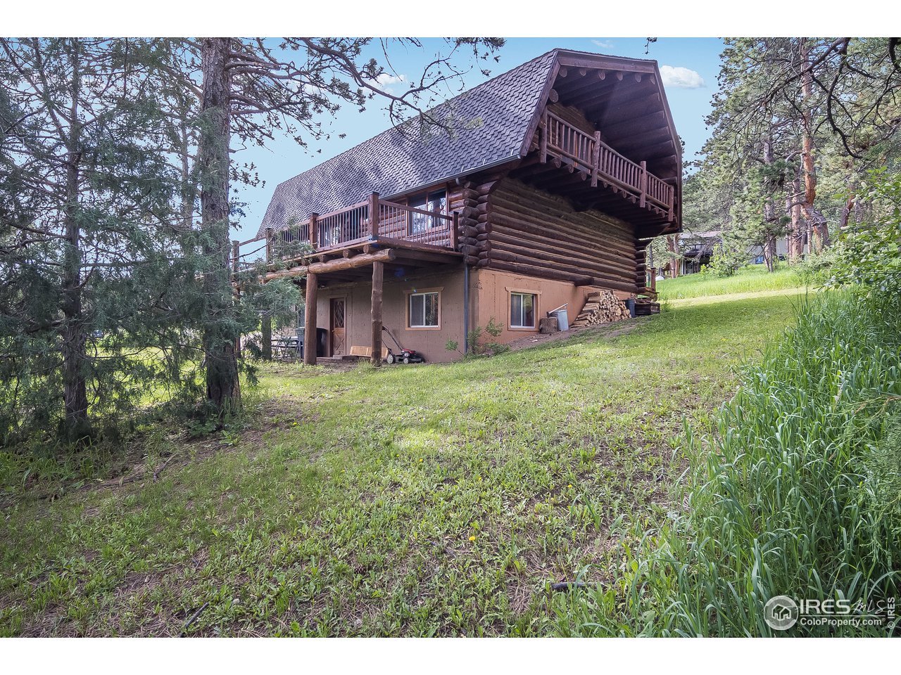 49 Moose Road Lyons, CO 80540 - Photo 16 of 40 a view of a house with a garden and deck