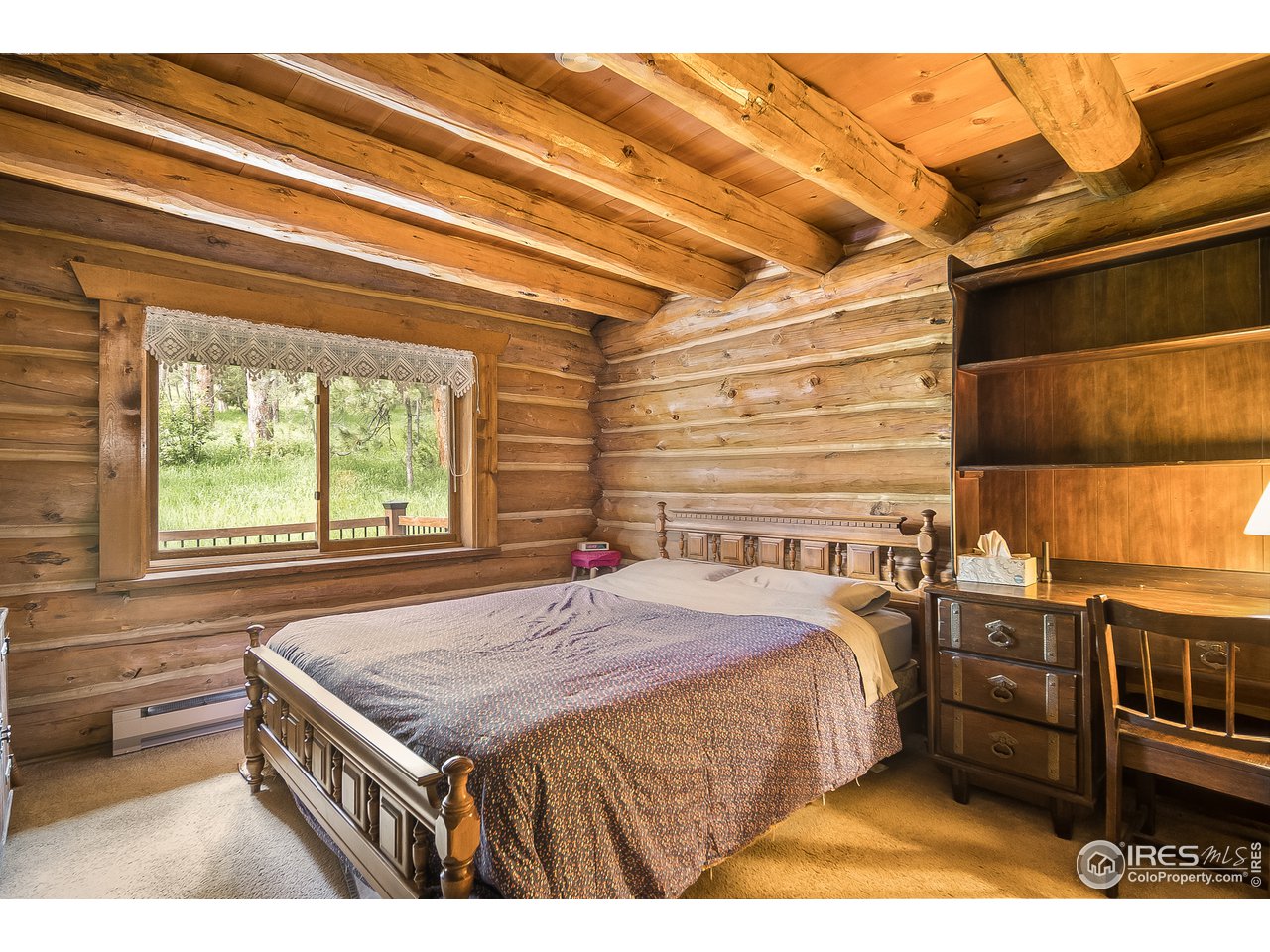 49 Moose Road Lyons, CO 80540 - Photo 28 of 40 a bedroom with a bed and a cabinets