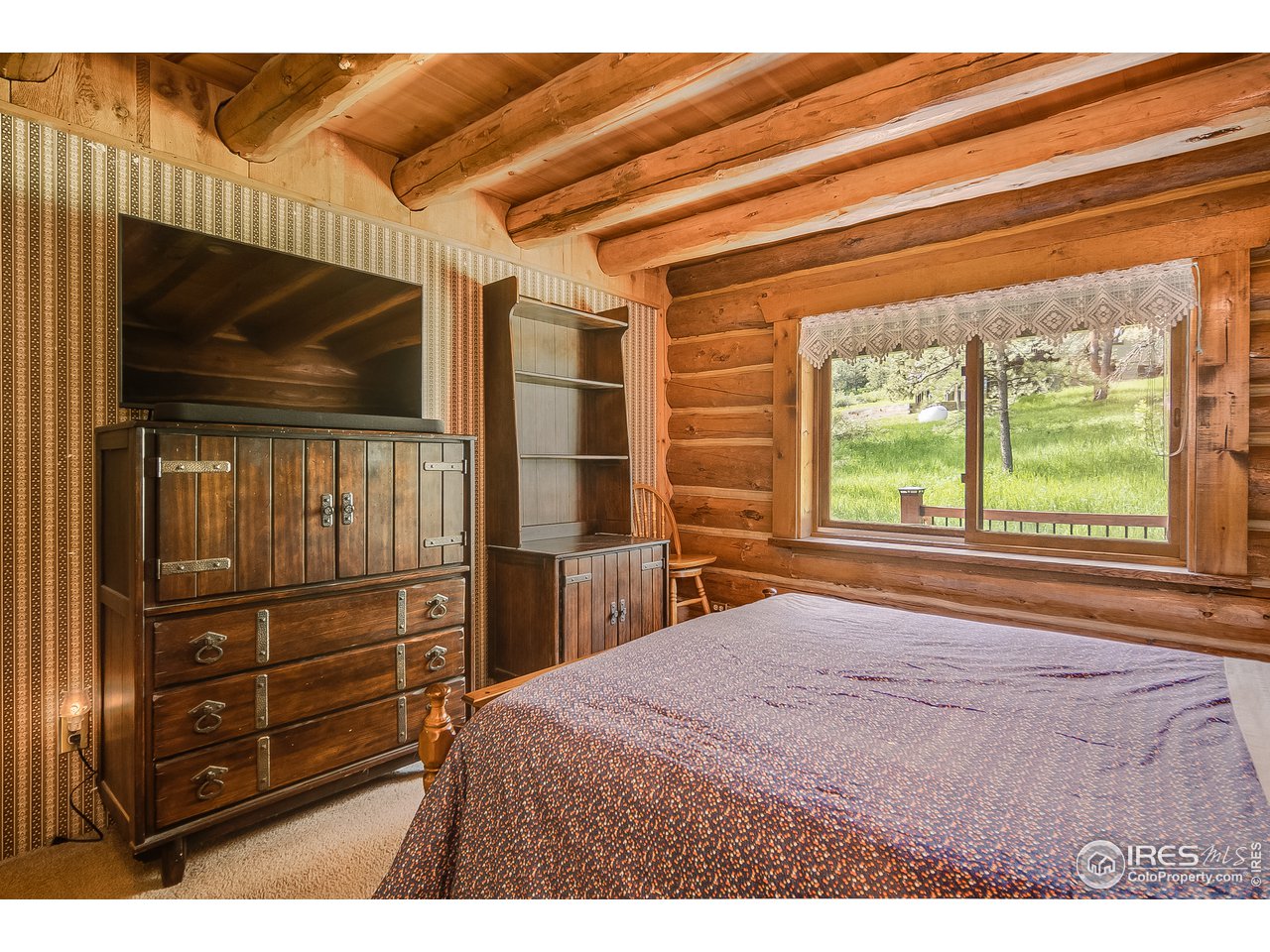 49 Moose Road Lyons, CO 80540 - Photo 29 of 40 a bedroom with a bed and a flat tv screen