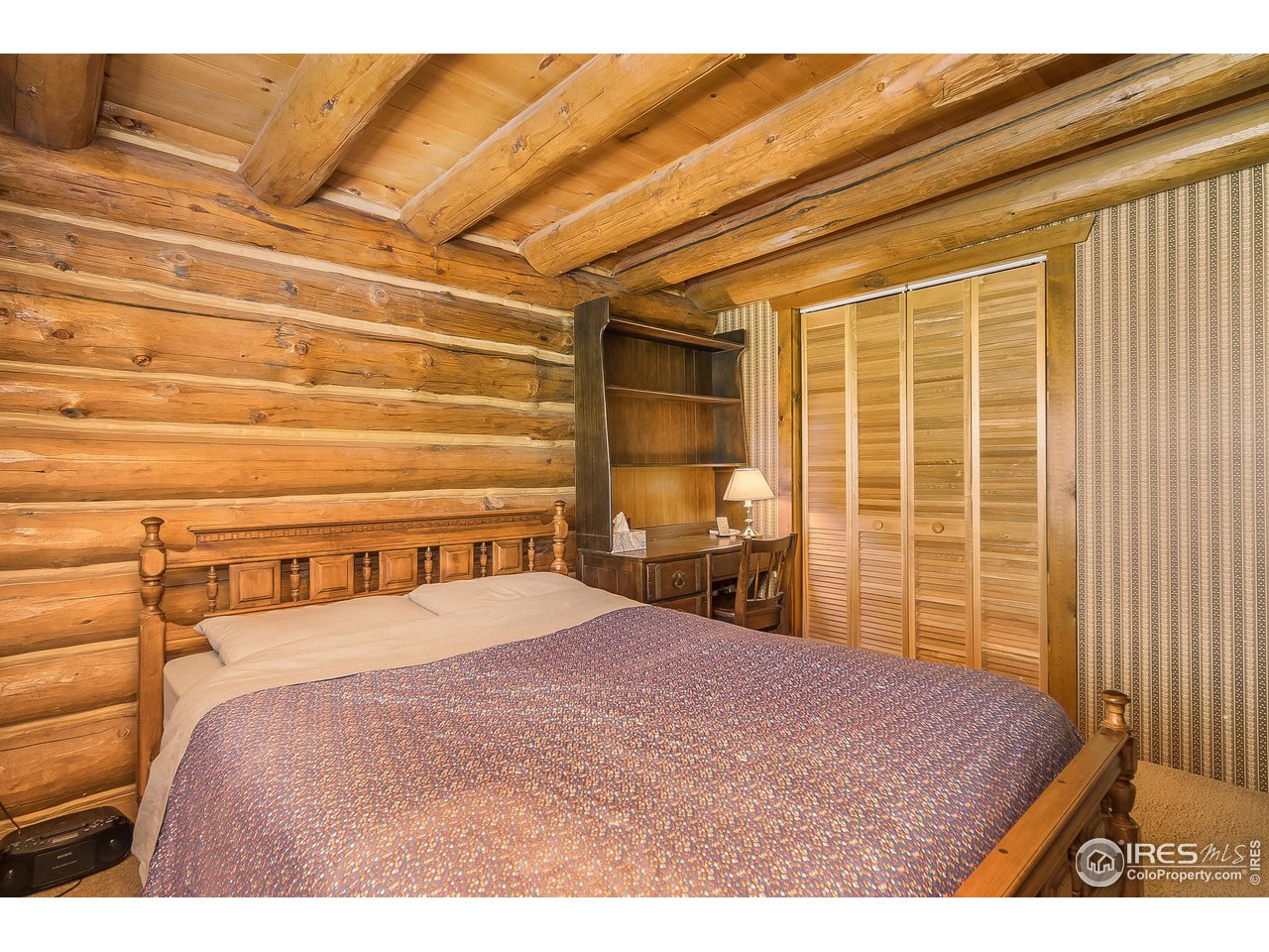 49 Moose Road Lyons, CO 80540 - Photo 30 of 40 a bedroom with a bed next to a window