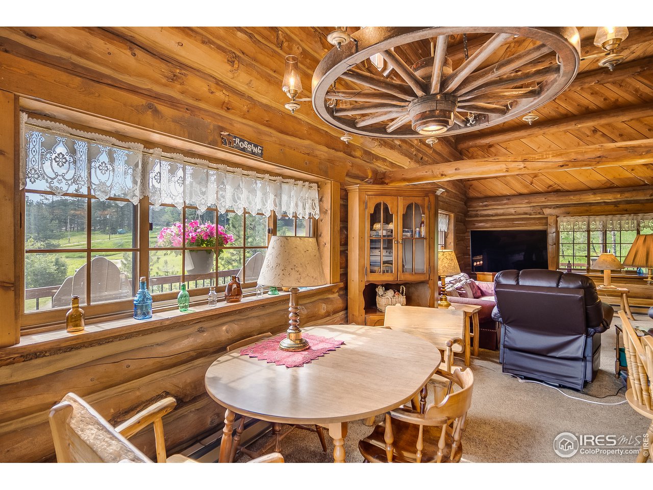 49 Moose Road Lyons, CO 80540 - Photo 8 of 40 a living room with furniture a flat screen tv and a large window