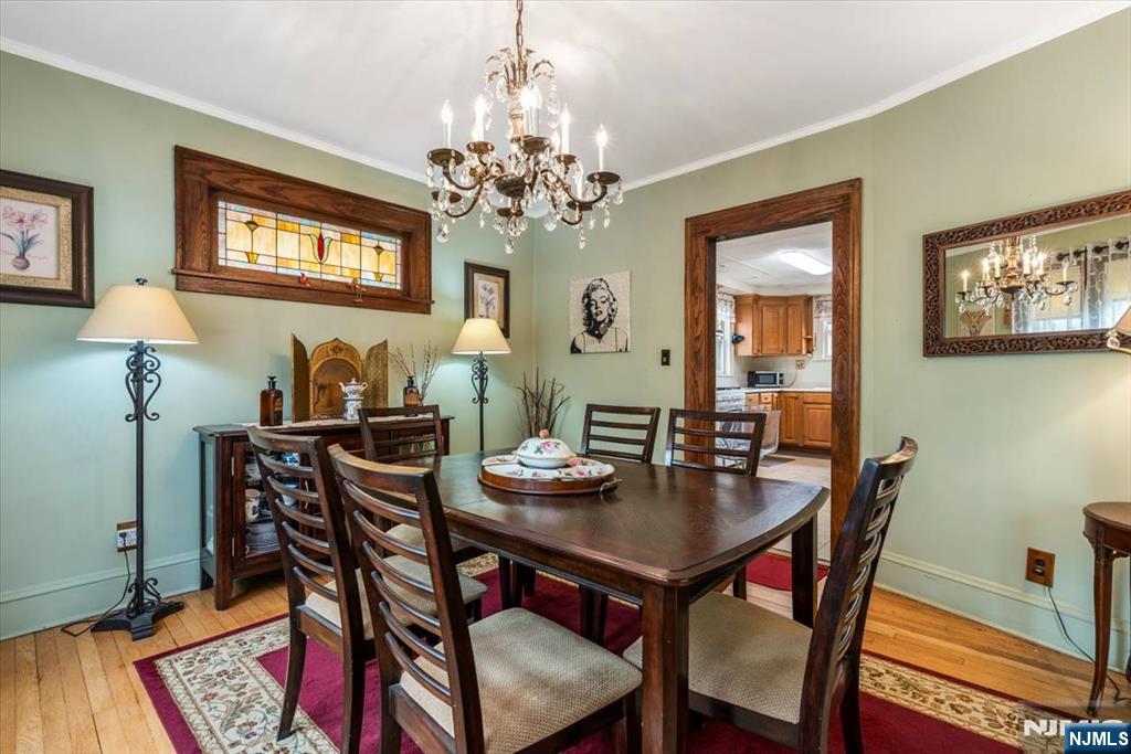 217 Mountain Way Rutherford, NJ 07070 - Photo 10 of 28 a dining room with furniture a chandelier and wooden floor