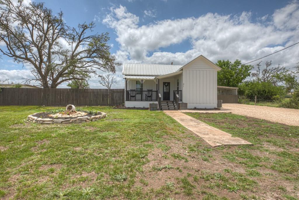 a view of a house with swimming pool and sitting area