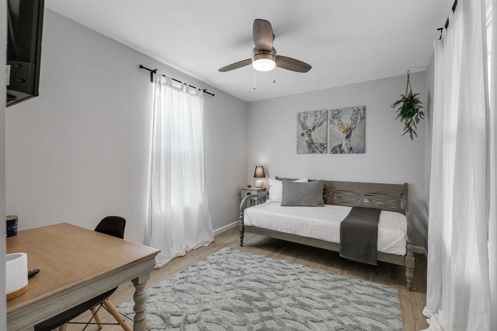 271 North Third Street Harper, TX 78631 - Photo 15 of 19 a bedroom with a bed and a chandelier