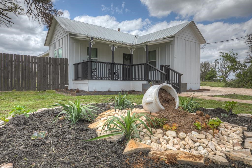 271 North Third Street Harper, TX 78631 - Photo 3 of 19 a front view of a house with garden