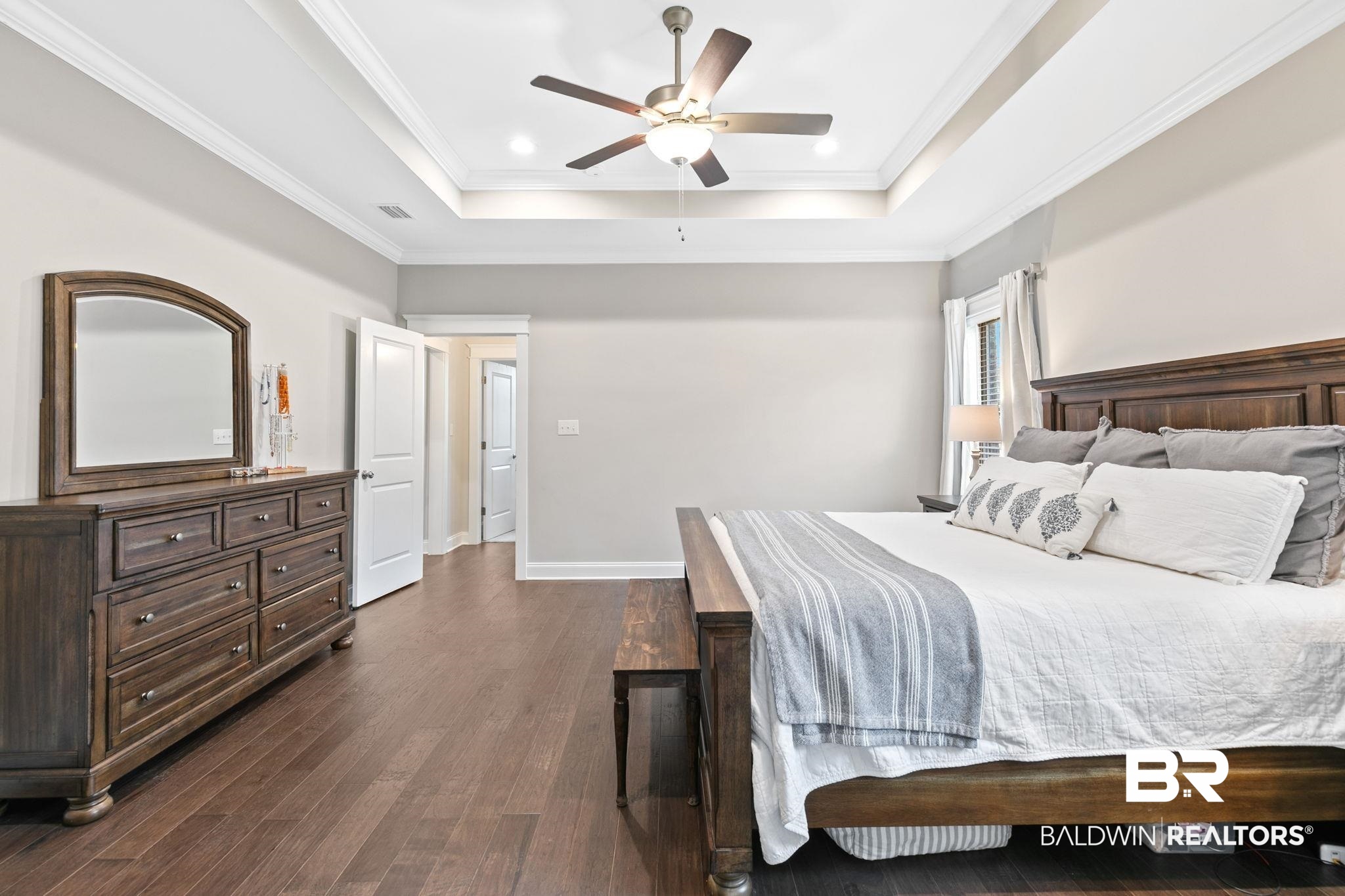13233 Ibis Boulevard Daphne, AL 36527 - Photo 28 of 100 Spacious room featuring wood-finish flooring, a tray ceiling with crown molding, and a ceiling fan