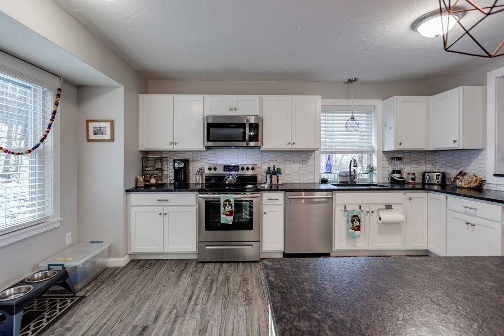 16 Vinton Road Holland, MA 01521 - Photo 15 of 32 a kitchen with stainless steel appliances granite countertop white cabinets a window and a sink