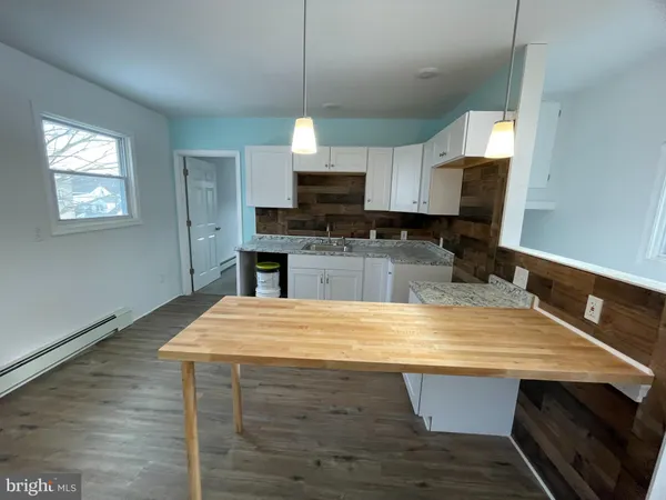 a kitchen with kitchen island a sink dishwasher a stove and a microwave oven