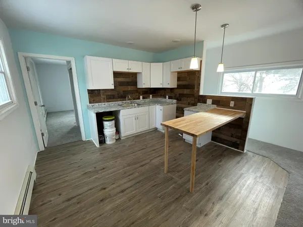 a kitchen with stainless steel appliances granite countertop a stove refrigerator sink and microwave