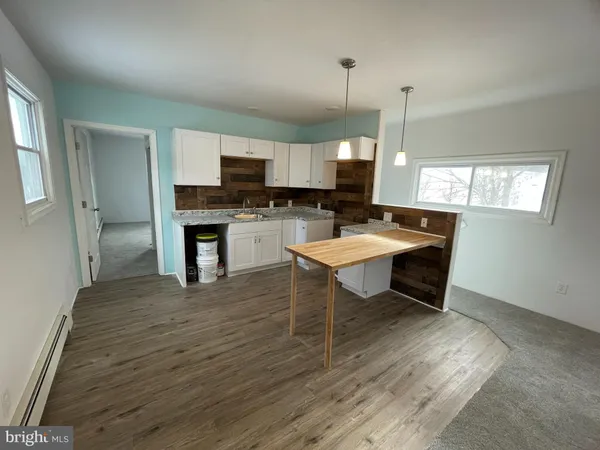 a kitchen with a sink dishwasher a stove and a refrigerator with wooden floor