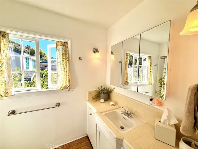 a bathroom with a sink a mirror and a shower