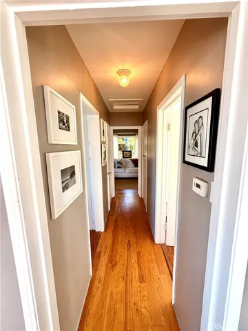 a view of a hallway view with wooden floor and staircase