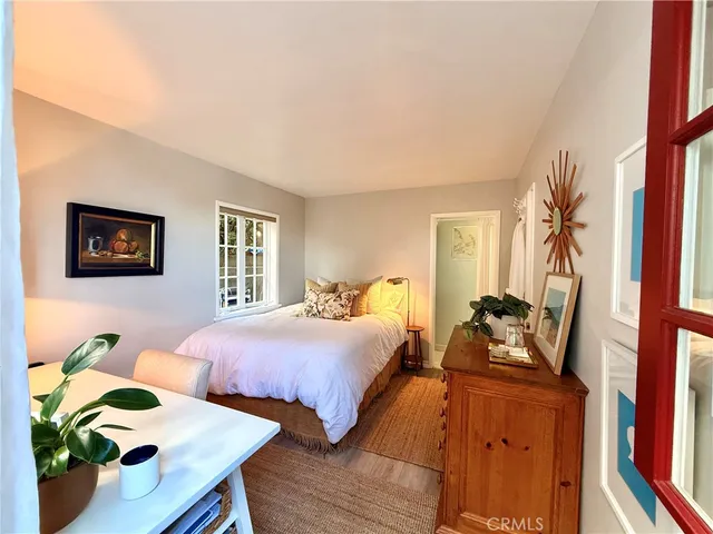 a bedroom with two beds and a potted plant