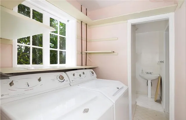 a close view of a utility room with dryer and washer