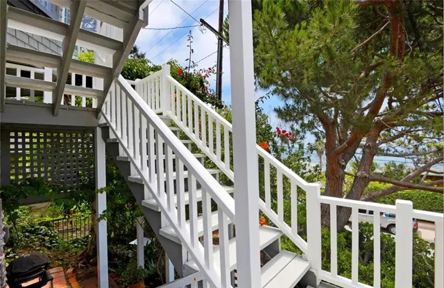 a view of staircase with railing and white walls
