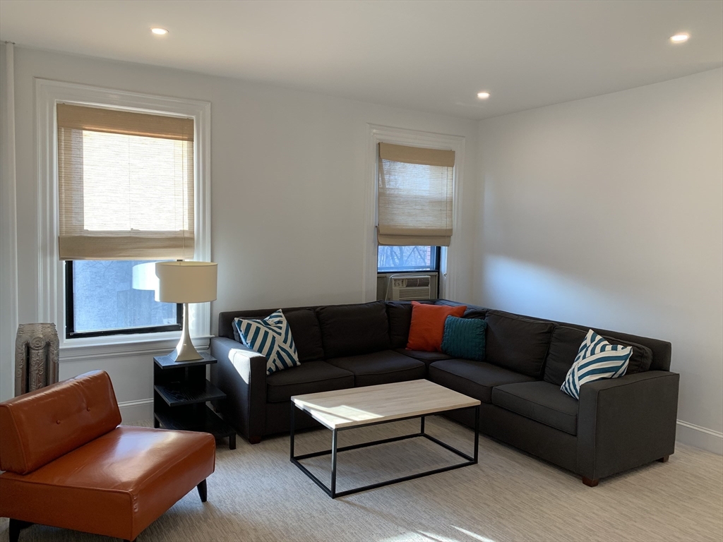 1064 Beacon Street, Unit 9 Brookline, MA 02446 - Photo 2 of 19 a living room with furniture and a window