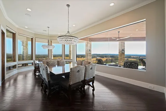 a living room with furniture a chandelier and a large mirror