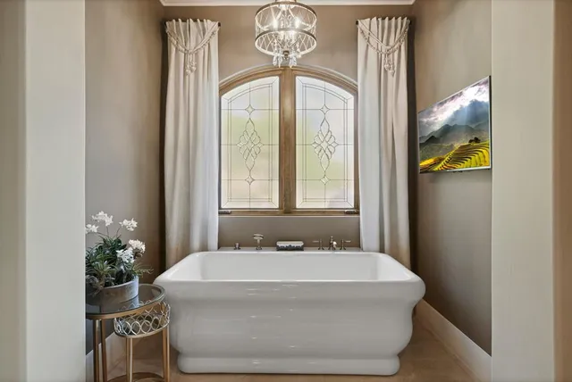 a bathroom with a granite countertop double vanity sink and a mirror