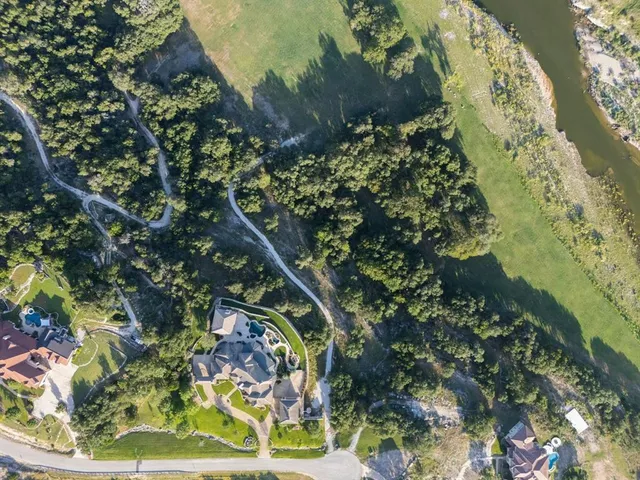 an aerial view of a house with a yard