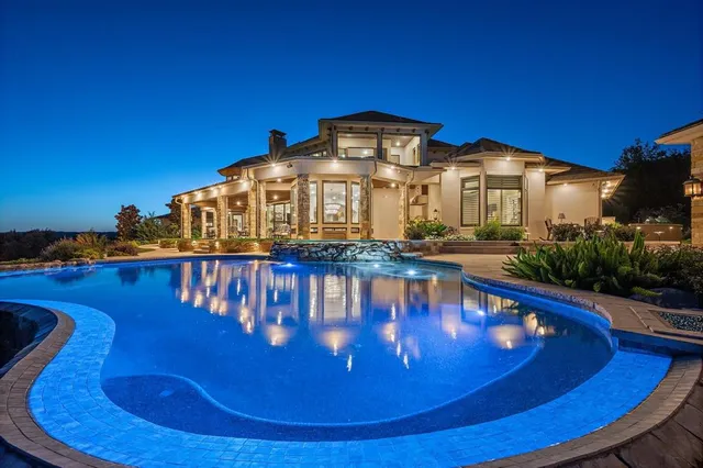 a view of a swimming pool and city from a balcony