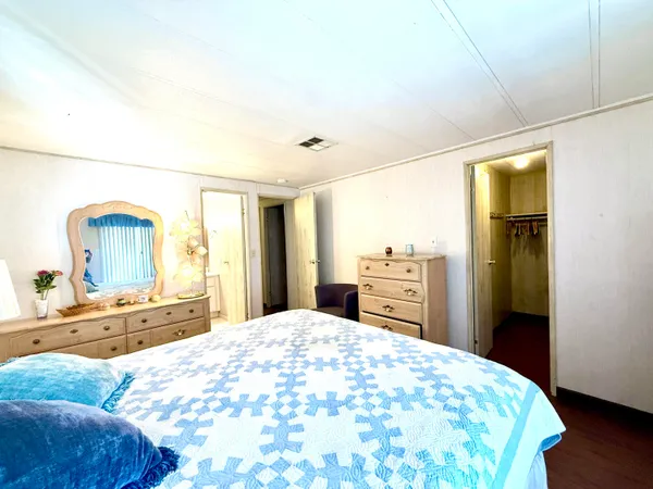 a bedroom with a bed and a dresser