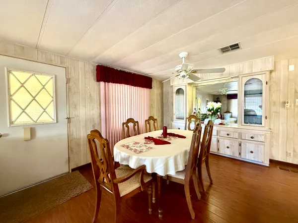 a view of a dining room with furniture and wooden floor
