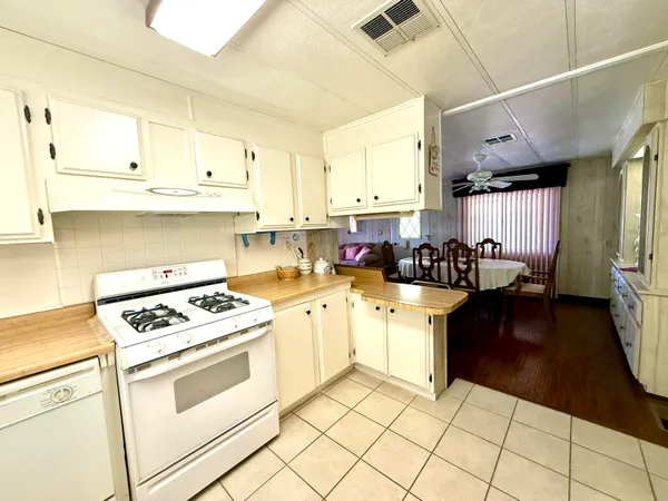 a kitchen with a stove a sink dishwasher and a refrigerator