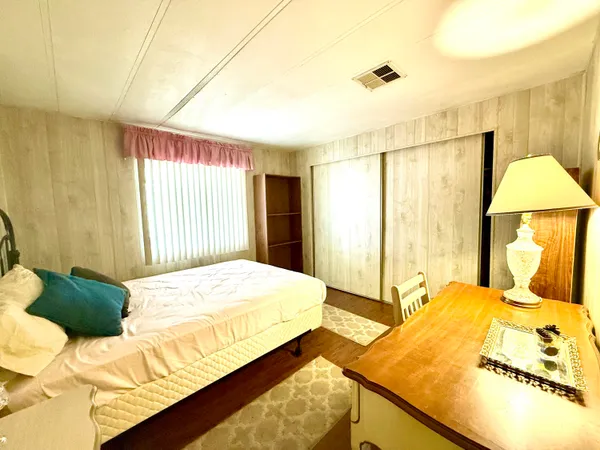 a bedroom with a bed and walk in closet