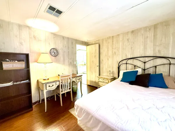a bedroom with a bed and a table