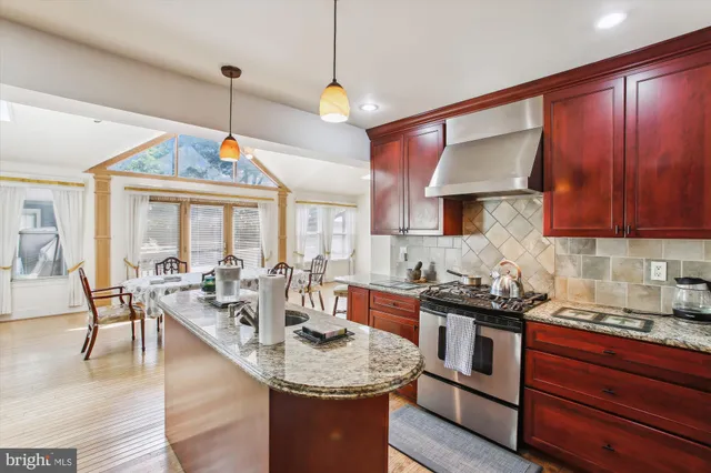 a kitchen with sink stove and cabinets