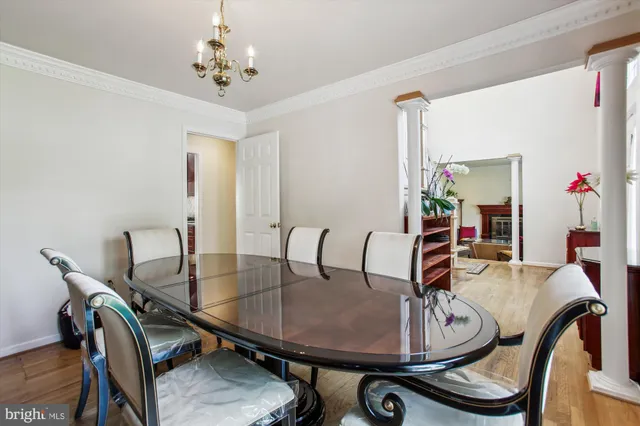 a dining room with furniture and wooden floor