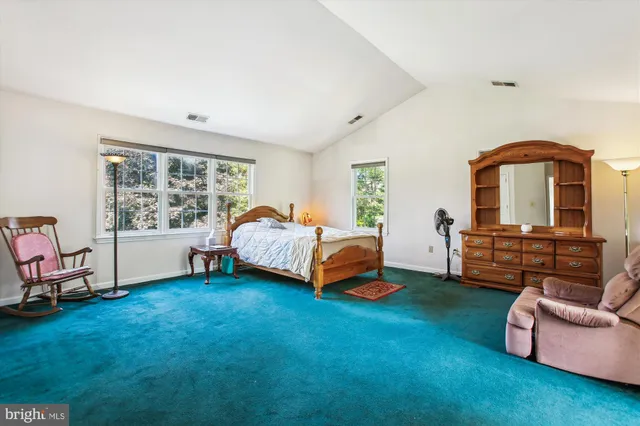 a bedroom with a bed and a couch