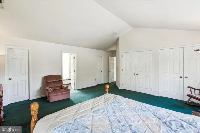 a bedroom with a bed and a couch