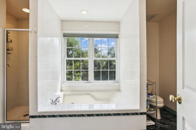 a bathroom with a bathtub and a window