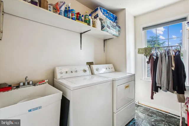 a view of a house with a big yard and large trees