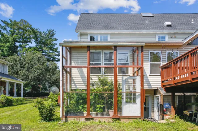 a view of backyard with a deck and wooden floor