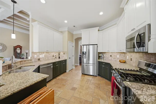 a kitchen with a sink stove and refrigerator