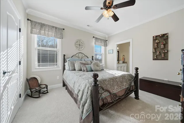 a bedroom with a bed and a dresser with the shoe rack