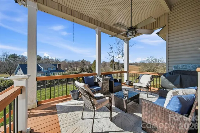 a balcony with furniture and a potted plant