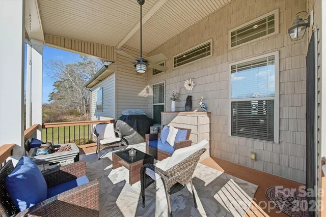 a living room with furniture a fireplace and a table