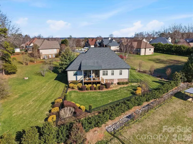 an aerial view of a house with garden space and lake view