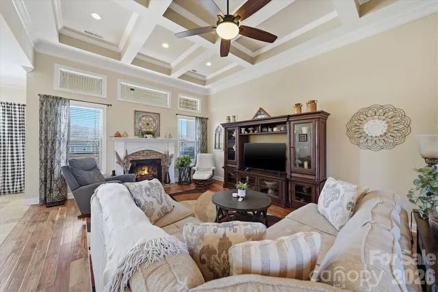 a living room with furniture a large window and a flat screen tv