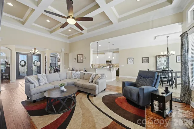 a living room with furniture or couches and a dining table with wooden floor